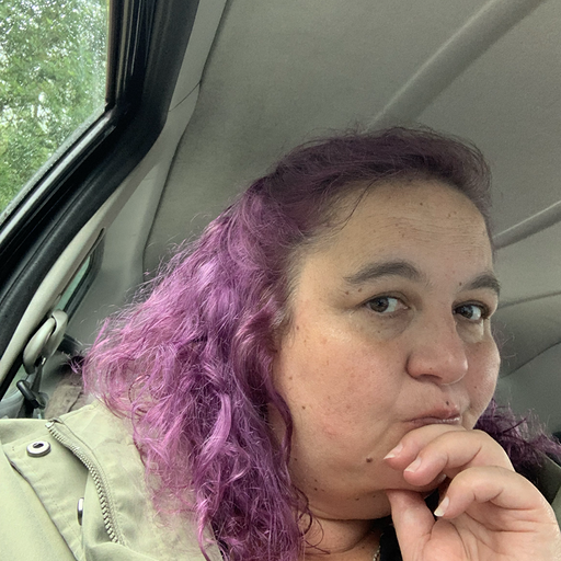 Me, a woman in her 50s with purple hair.